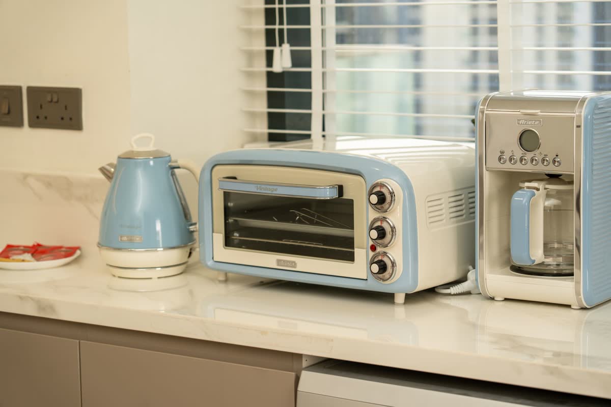 Small kitchen appliances lined up on a counter