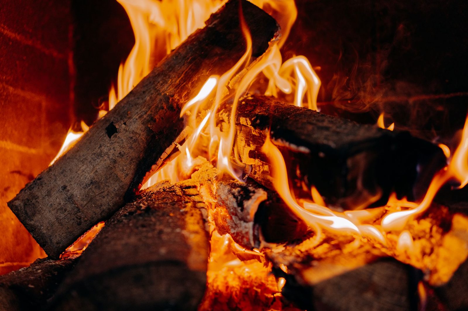 Logs burning brightly in a fireplace