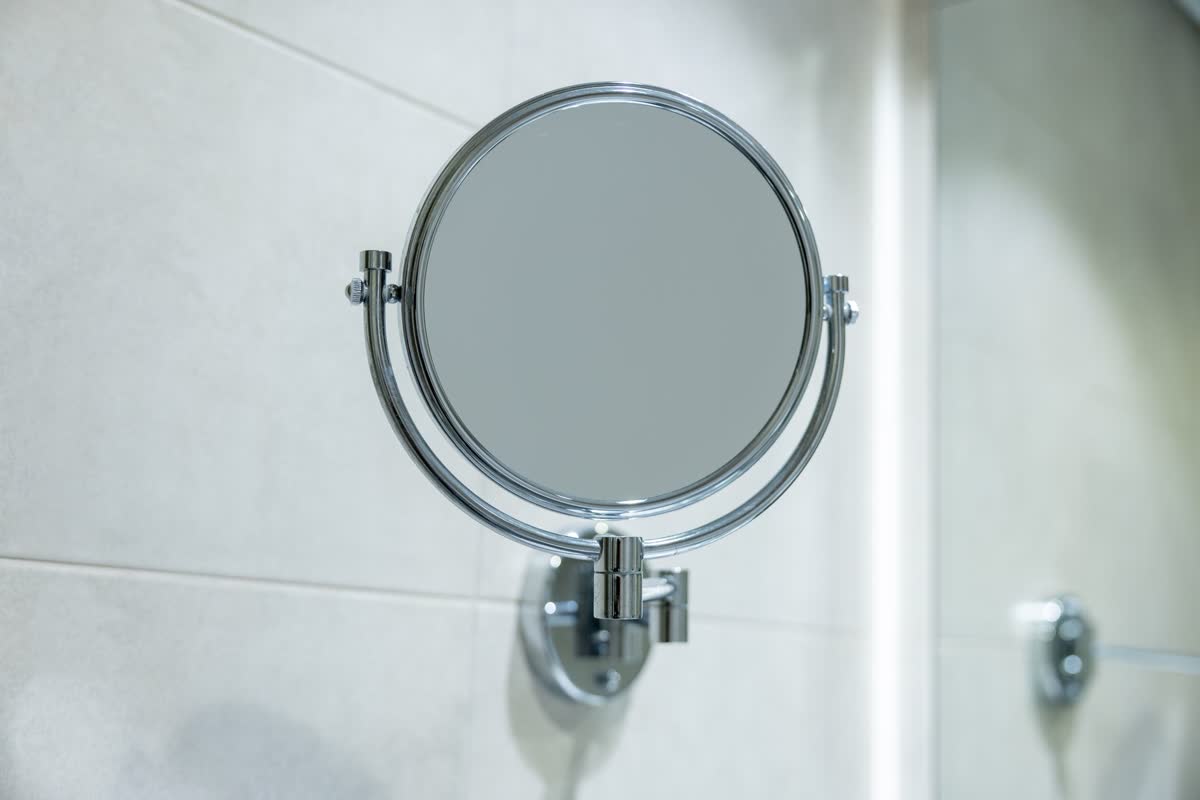 Un petit miroir rond sur un mur