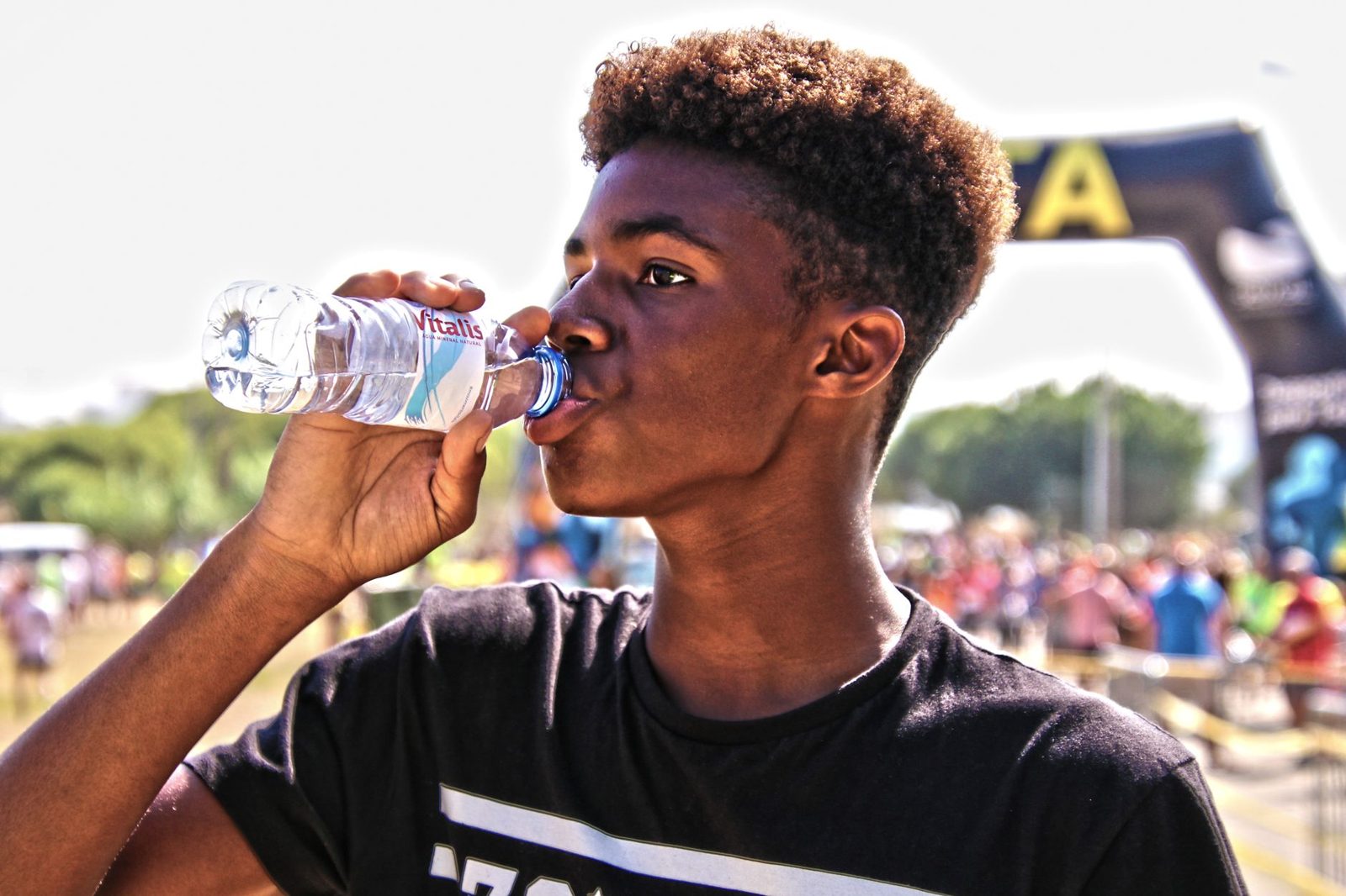 A person drinking water on a hot day