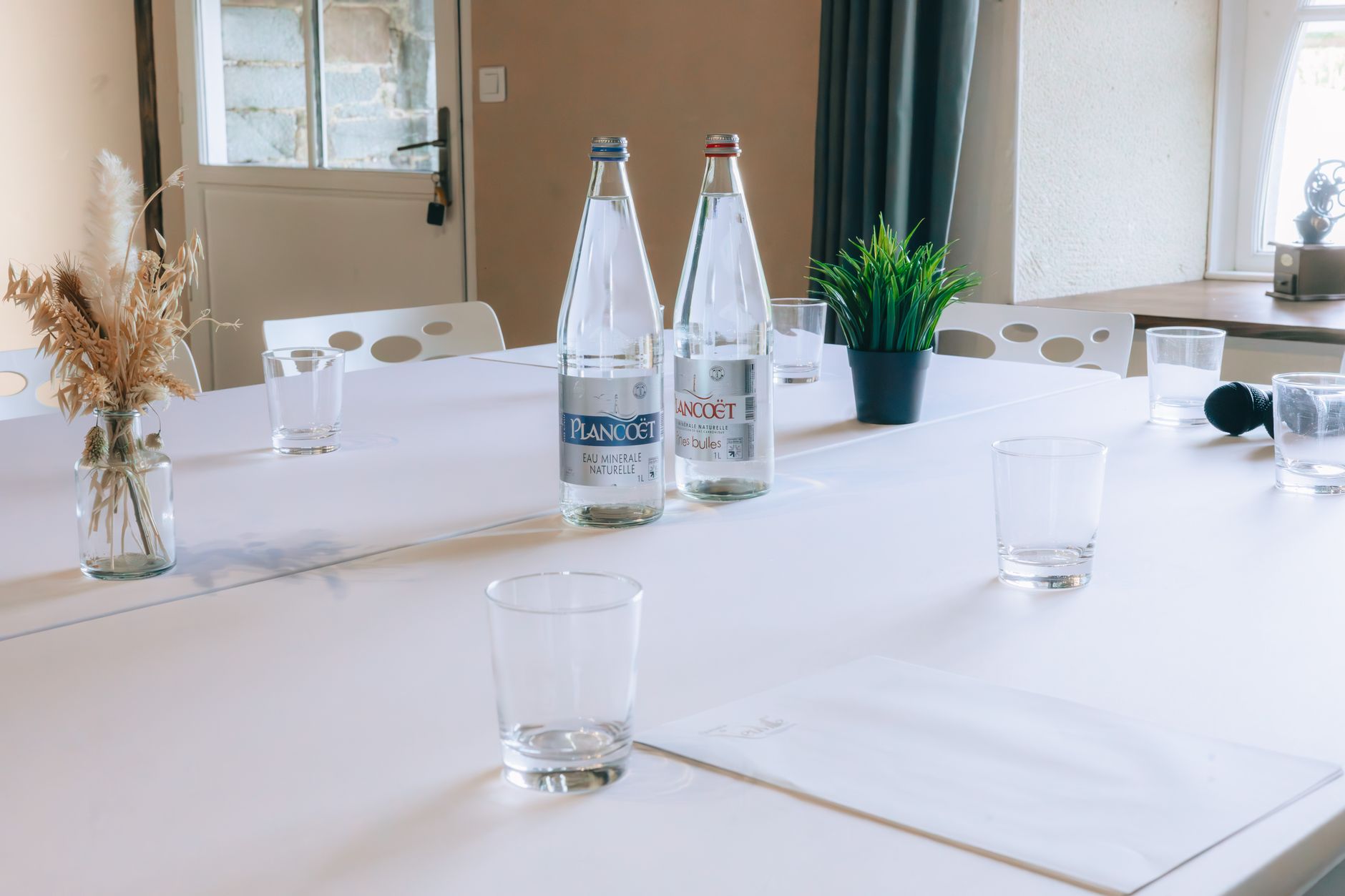 A glass and bottle of cold water