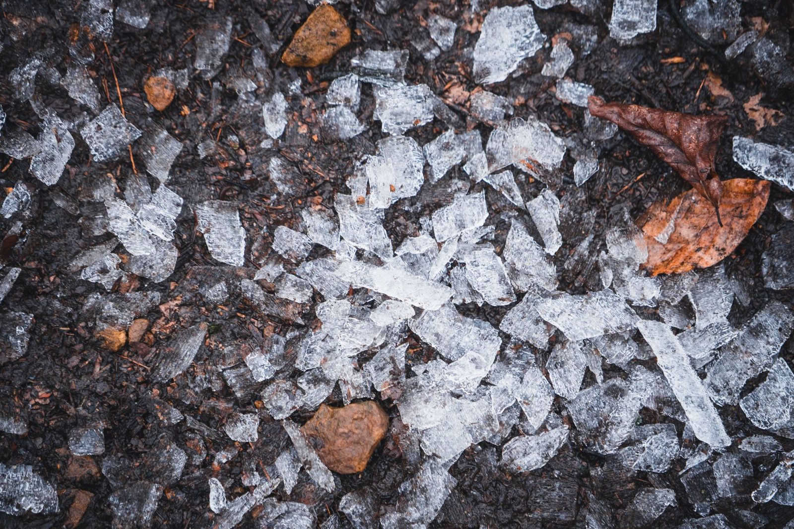 Ice melt crystals spread on a snowy surface